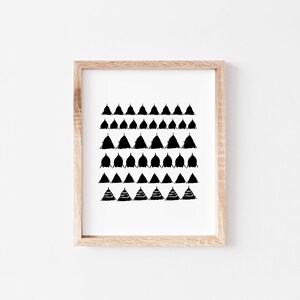 May include: A framed black and white print featuring a geometric pattern of triangles. The triangles are arranged in rows and are of varying sizes.