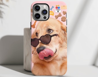 May include: A pink iPhone case with a golden retriever wearing heart-shaped sunglasses and sticking its tongue out. The case is decorated with dog-themed icons, including a bone, a paw print, and the word "Woof".