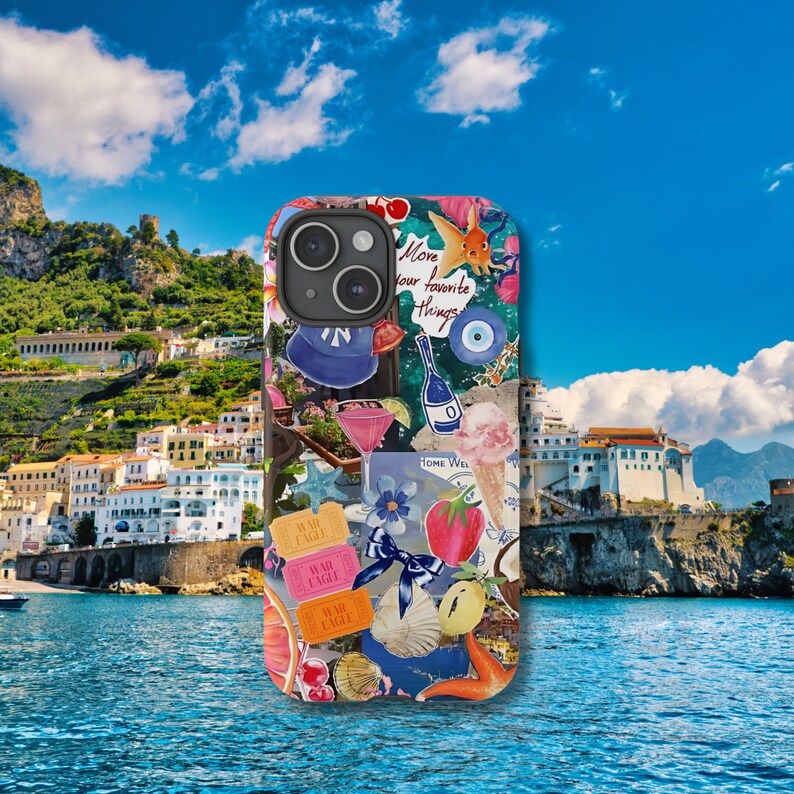 May include: A colorful phone case with a collage of images, including a fish, a cocktail, a strawberry, and the text "Move your favorite things".
