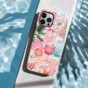 May include: A pink and white phone case with a tropical and cocktail theme. The case features a starfish, a grapefruit, a pink drink, a martini glass, a bow, a turtle, and a magazine cover that says "COAST".
