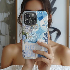 May include: A blue and white phone case with a collage of images, including seashells, flowers, and the text "Free Like The Ocean".