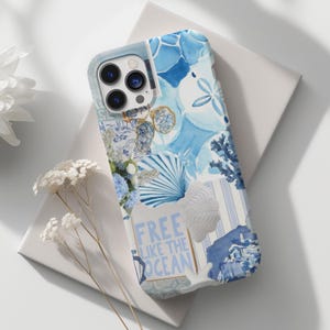 May include: A blue and white phone case with a collage of images, including a seashell, a palm leaf, and the text "Free Like The Ocean".