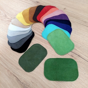 Puede incluir: Surtido de 18 parches de cuero de gamuza en varios colores, incluyendo rojo, azul, verde, amarillo y gris. Los parches son de forma ovalada con un borde cosido.