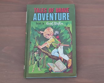 May include: A green book with the title "Tales of Brave Adventure" and the words "Retold by Enid Blyton" on the cover. The cover features an illustration of a boy with blonde hair and a green shirt holding a bow and arrow, standing on a tree branch.