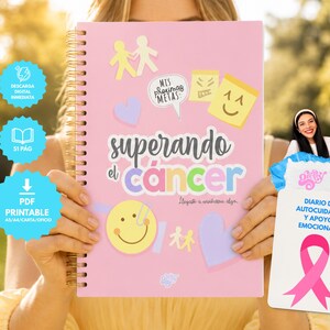 Puede incluir: Un cuaderno de espiral rosa titulado Superando el cáncer con ilustraciones coloridas que incluyen una cara sonriente amarilla, corazones y notas adhesivas. Una tarjeta blanca separada muestra un lazo rosa y el texto Diario de autocuidado y apoyo emocional.