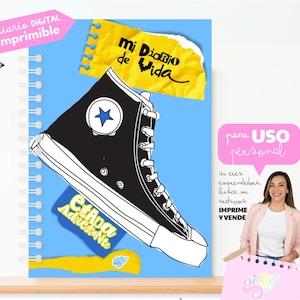 Puede incluir: Un cuaderno de espiral con una cubierta azul que presenta una ilustración en blanco y negro de una zapatilla de caña alta. El cuaderno tiene texto en español, incluyendo "diario DIGITAL imprimible" y "Mi Diario de Vida."