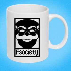 May include: White ceramic mug featuring a black and white image of a man's face with a moustache and the text "Fsociety" printed on the front.