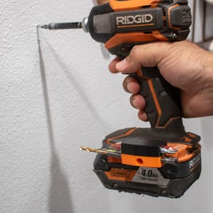 Ridgid drill with bit holder being used