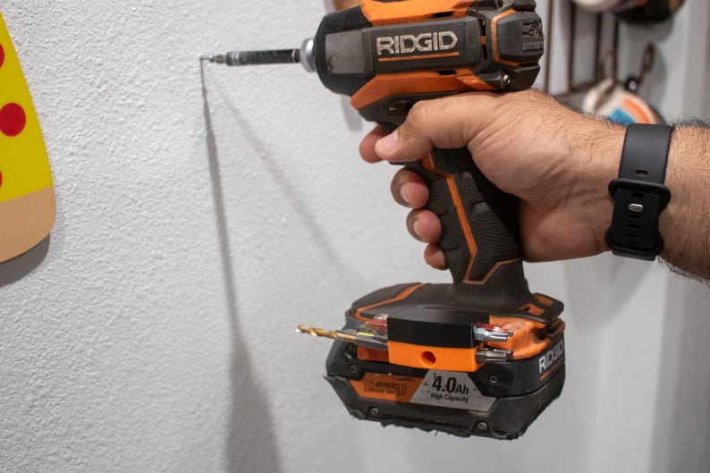 Ridgid drill with bit holder being used