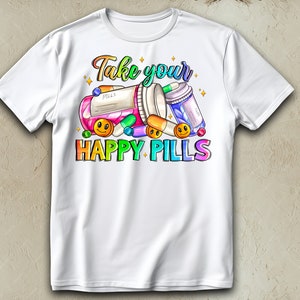 May include: White t-shirt with a colorful graphic design of pills and the text "Take your happy pills".