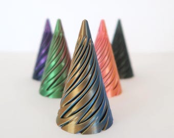 May include: Six decorative cone-shaped objects in a range of colours: purple, green, gold, coral, and black. Each cone has a spiral design and metallic sheen, set against a white background.