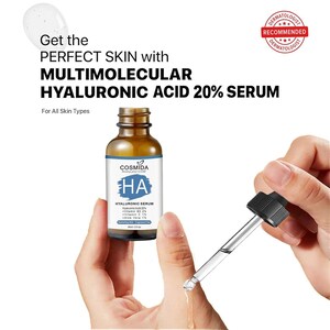 May include: A brown glass bottle of COSMIDA hyaluronic acid serum with a blue and white label. The label reads "HA HYALURONIC SERUM" and "20% Serum". A dropper is held above the bottle, with the text "Get the PERFECT SKIN with MULTIMOLECULAR HYALURONIC ACID 20% SERUM".