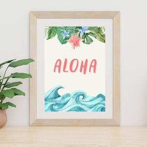 May include: A framed print featuring a watercolour design of tropical leaves, flowers, and ocean waves. The text "ALOHA" is written in pink letters.