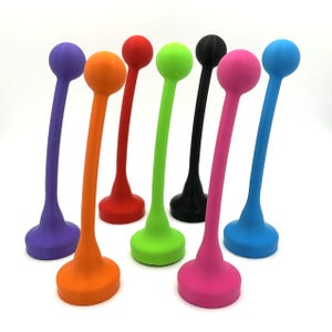 May include: A collection of colorful, abstract, curved objects. Each object has a round top and a base, with a slender, curved stem connecting them. The colors include purple, orange, red, green, black, pink, and blue.