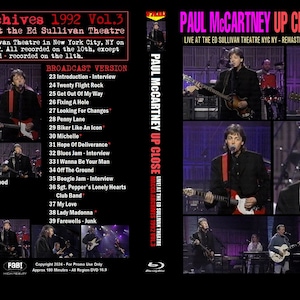 May include: A blue-ray disc case with a photo of Paul McCartney performing live on stage. The case is for a concert recording titled "Paul McCartney Up Close 1992" and features the text "Live at the Ed Sullivan Theatre NYC NY - Remastered Video - Hi Fi Stereo Recording".