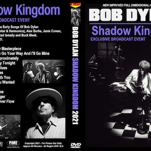 May include: A DVD cover for Bob Dylan's "Shadow Kingdom" concert, featuring a black and white photo of Bob Dylan playing guitar on a stage with a checkered floor. The cover also includes a list of songs on the DVD, including "When I Paint My Masterpiece", "Most Likely You Go Your Way And I'll Go Mine", and "Queen Jane Approximately".