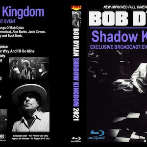 May include: Blu-ray disc case for Bob Dylan's "Shadow Kingdom" broadcast event. The cover features the title in white and purple, with a live performance image. The back lists the song titles and credits.