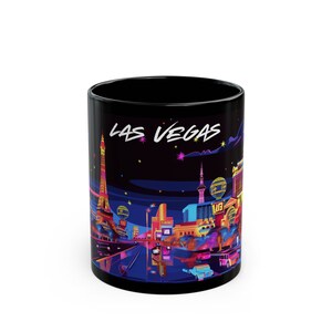May include: Black ceramic mug with a colorful illustration of the Las Vegas skyline at night. The mug features the text "LAS VEGAS" in a white, stylized font.
