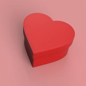 Puede incluir: Una caja roja en forma de corazón con un borde negro. La caja está sobre una superficie rosa.