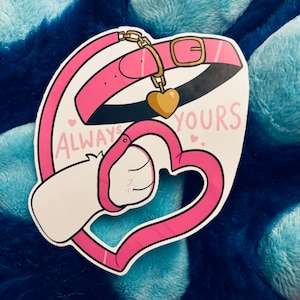Puede incluir: Una pegatina con un collar rosa con hebilla dorada y dije de corazón, conectado a un diseño de esposas en forma de corazón rosa. Las palabras "ALWAYS YOURS" están escritas en rosa, con pequeñas ilustraciones de corazón.