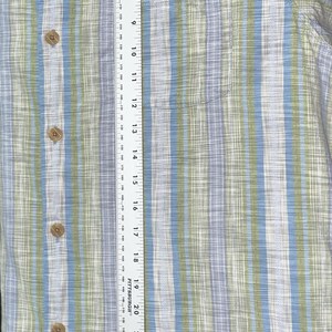 May include: A button-down shirt with vertical stripes in blue, green, and white. The shirt has a chest pocket and wooden buttons. The shirt measures approximately 30 inches in length.