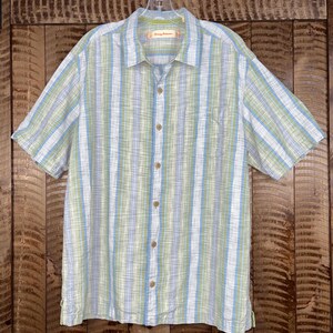 May include: A handmade wooden sign with the text "Welcome" in a playful font. The sign is painted white with a distressed finish, and features a decorative floral design in shades of pink and green. It is designed for indoor or outdoor use.