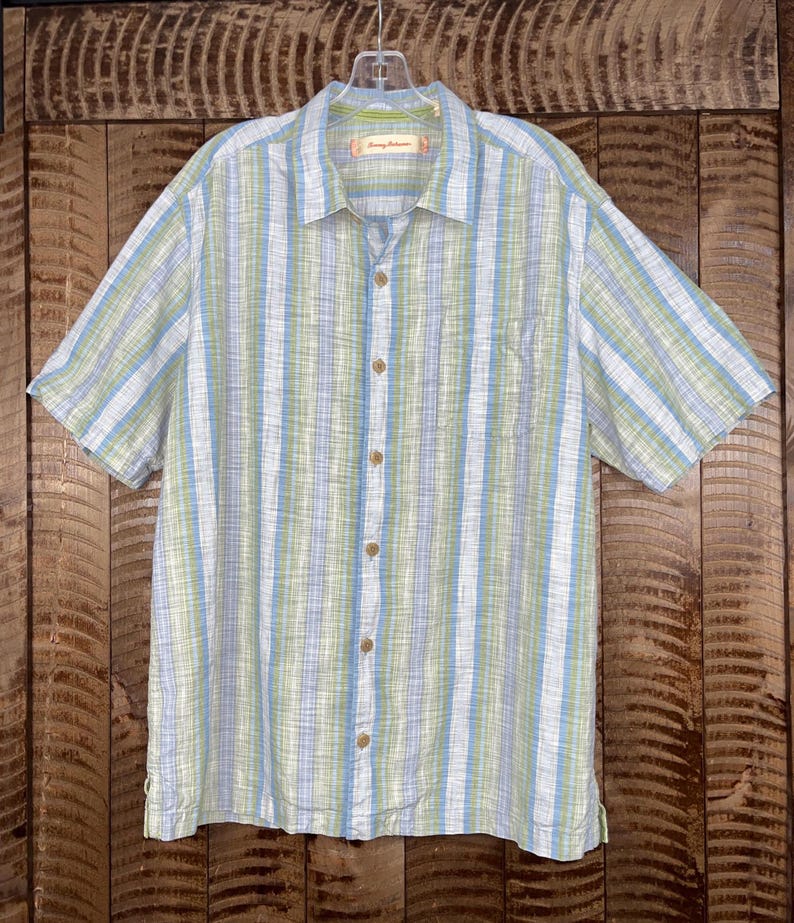 May include: A handmade wooden sign with the text "Welcome" in a playful font. The sign is painted white with a distressed finish, and features a decorative floral design in shades of pink and green. It is designed for indoor or outdoor use.