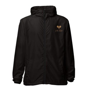 May include: Black hooded windbreaker jacket with a full zipper closure. The jacket features a small logo of two crossed pickleball paddles and the word "pickle" in a brown color.