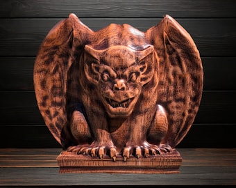 Può includere: Una scultura dettagliata di gargoyle in legno con ali spiegate, artigli affilati e un'espressione minacciosa. La statua è di colore marrone-rossastro e poggia su una base rettangolare.