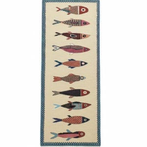 May include: A rectangular rug with a cream-colored background and a border of blue geometric patterns. The rug features a repeating pattern of stylized fish in various colors, including red, pink, and black. The rug has a fringed edge.