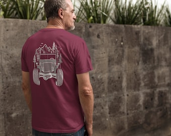 May include: A maroon t-shirt with a gray graphic of a jeep driving through a mountain landscape with trees on either side.