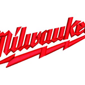 May include: A red embroidered logo featuring the word Milwaukee in a stylized, slanted font with a sharp, lightning-bolt-shaped underline extending from the letter M to the end of the word, creating a bold and distinct graphic design element.