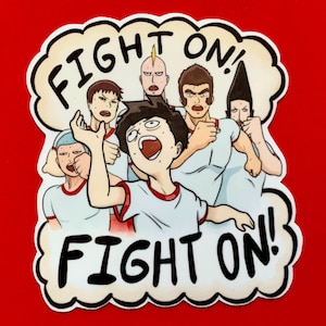 May include: A sticker with a cartoon illustration of a group of people in athletic attire, with the words "FIGHT ON!" in a cloud-shaped border. The characters have various hairstyles and expressions, set against a red background.