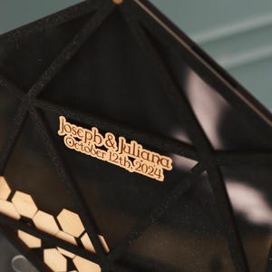 May include: Black geometric wedding card box with a wooden sign that reads "Joseph & Juliana October 12th, 2024".
