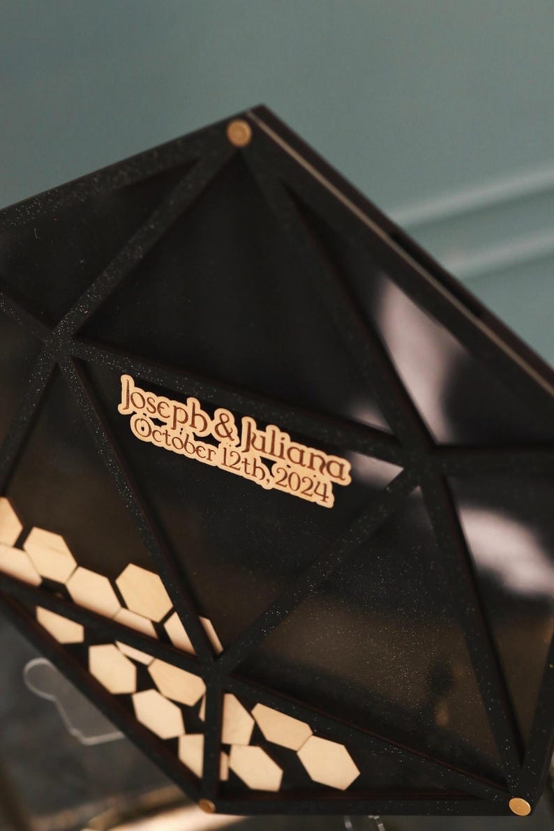 May include: Black geometric wedding card box with a wooden sign that reads "Joseph & Juliana October 12th, 2024".