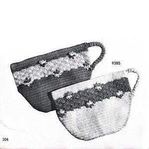 May include: Two crocheted cup cozies in black and white with a flower design. The cozies are shaped like cups with handles. The pattern number 9385 is printed on the image.