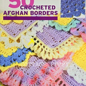 May include: A book cover featuring 50 crocheted afghan borders in various colors, including pink, yellow, blue, and purple. The title "50 CROCHETED AFGHAN BORDERS" is displayed in large, bold letters. The book cover also includes a smaller image of a crocheted border in blue.