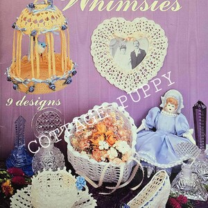 May include: A vintage crochet pattern book titled "Thread Crochet Whimssies" featuring 9 designs. The cover shows a crocheted birdcage, a heart-shaped doily, a crocheted basket of flowers, a doll, and a crocheted shoe.