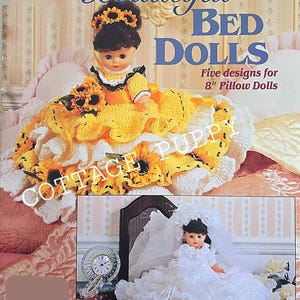 May include: Crochet pattern book for making five different bed dolls. The cover features a doll wearing a yellow dress with sunflowers and a white crocheted bed.