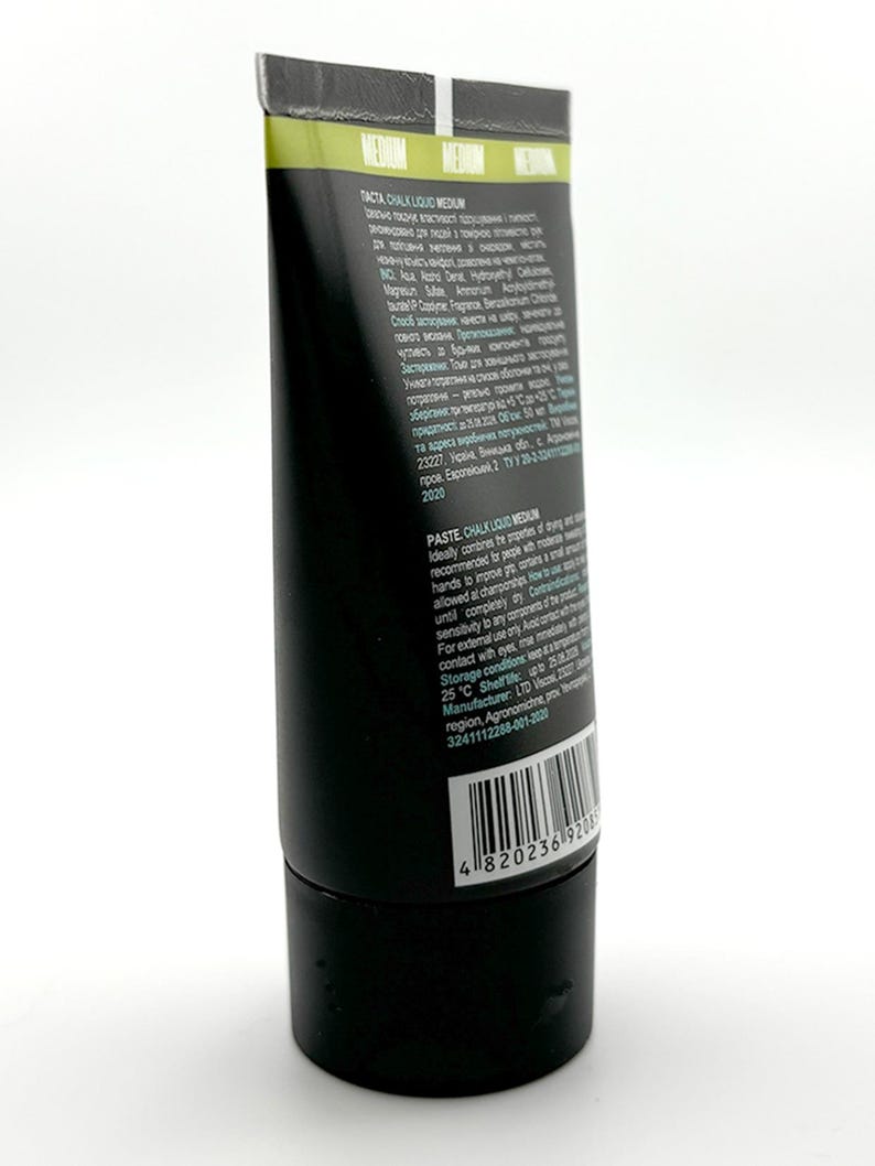Może przedstawiać: Czarna tuba "TACTA CHALK LIQUID MEDIUM" z białym i zielonym tekstem. Tuba ma czarną nasadkę i kod kreskowy. Produkt to pasta do farbowania i jest zalecany do poprawy sk&oacute;ry.