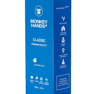 May include: Blue box with a white monkey logo and the text "MONKEY HANDS" in white. The box contains a 100 ml (3.4 oz) bottle of "CLASSIC PREMIUM QUALITY" hand cream. The box lists several features, including "hypoallergenic", "made in our own factory", "cosmetic grade", "locally sourced ingredients", "developed in our own lab", "cruelty free", "vegan", "made with PCR", "travel friendly", "paraben free", "fragrance free", "petroleum free", and "toxic chemical free".