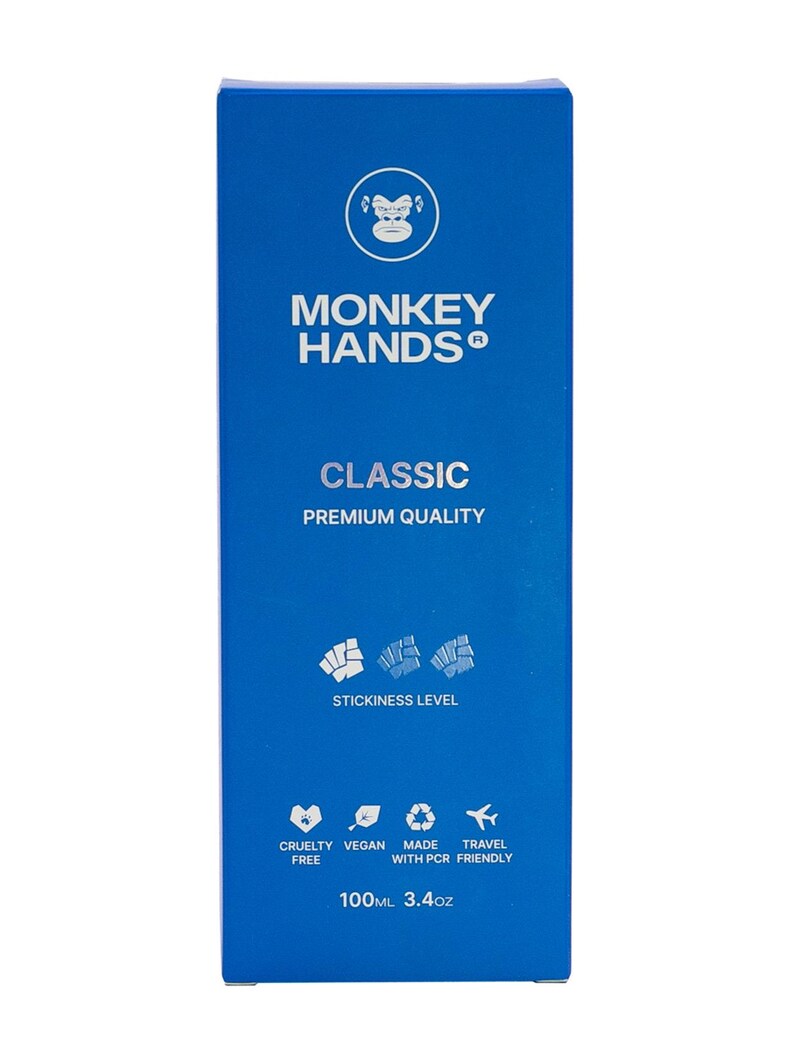 May include: Blue box with a monkey logo and the text "MONKEY HANDS" and "CLASSIC PREMIUM QUALITY". The box also has a stickiness level indicator, a list of product features, and the text "100ML 3.4oz".