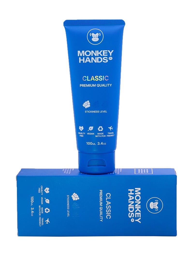 May include: A blue tube of Monkey Hands Classic Premium Quality hand cream with a monkey logo. The tube is 100 ml or 3.4 oz. The tube is sitting on top of a blue box with the same logo and text.