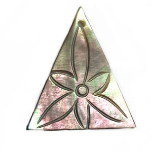 May include: A triangular pendant made of iridescent mother of pearl with a carved flower design.