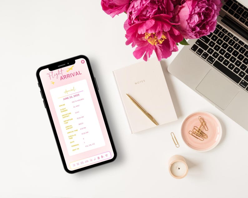 May include: A pink and white smartphone displaying a flight arrival list for June 22, 2018. The list includes flight numbers, airlines, and arrival times. The phone is on a white surface with a pink notebook, a gold pen, a pink dish with gold paper clips, and a white candle.