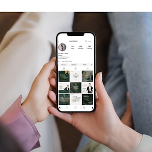 May include: A person holding a black smartphone displaying a social media profile. The profile showcases a law firm's branding with a dark green and gold color scheme. The screen displays the username "yourlawyer" and various posts.