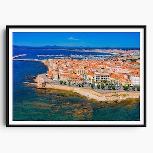 May include: Aerial view of a coastal city with red-tiled roofs, buildings, and a harbor. The city is surrounded by blue water and a clear sky. A stone wall and a tower are visible.