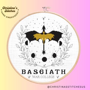 May include: Black and gold embroidery pattern of a dragon with wings spread, surrounded by stars and crescent moons. The text "BASGIATH WAR COLLEGE" is below the dragon.