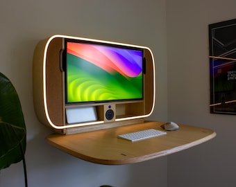 May include: A modern, wall-mounted desk with a built-in monitor. The desk is made of light-colored wood and features a curved design with a glowing LED light. A keyboard and mouse sit on the desk.