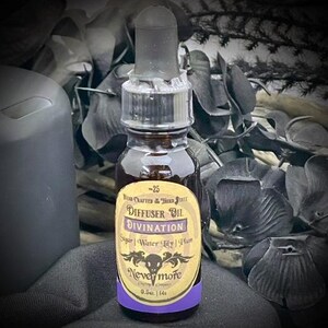 May include: A dark glass bottle with a dropper top, labeled "Diffuser Oil Divination" with the brand "Nevermore." The label includes ingredients: Sugar, Water Lily, and Plum. The bottle contains 0.5 fl oz.